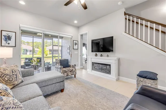 a kitchen with stainless steel appliances granite countertop white cabinets a sink a stove a refrigerator and white cabinets