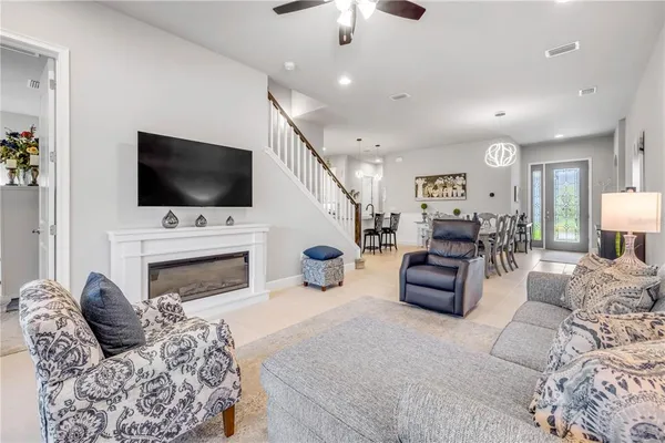 a kitchen with stainless steel appliances granite countertop white cabinets a sink a stove a refrigerator and white cabinets