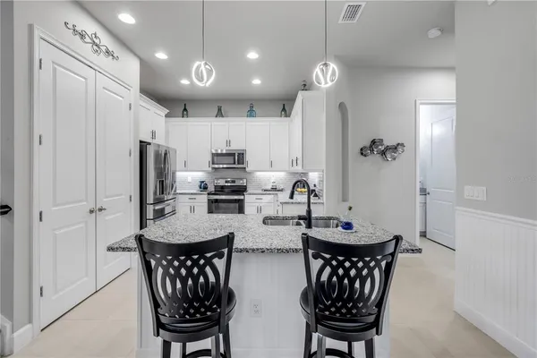 a bathroom with a granite countertop sink a mirror and vanity