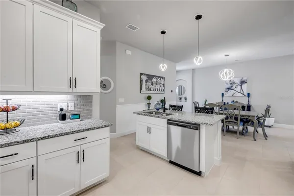 a en suite bathroom with a granite countertop sink and a mirror