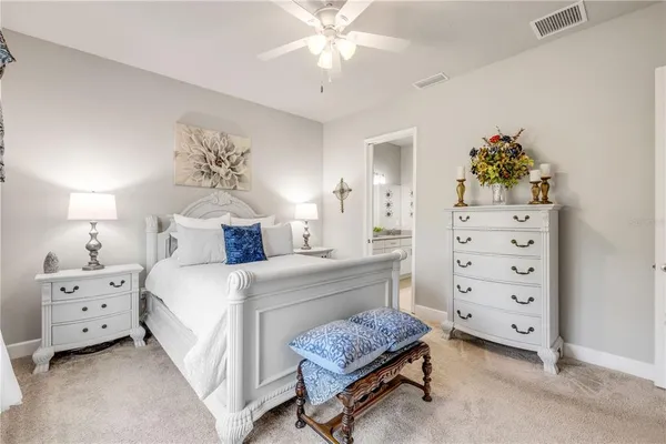 a bedroom with a bed and a large mirror