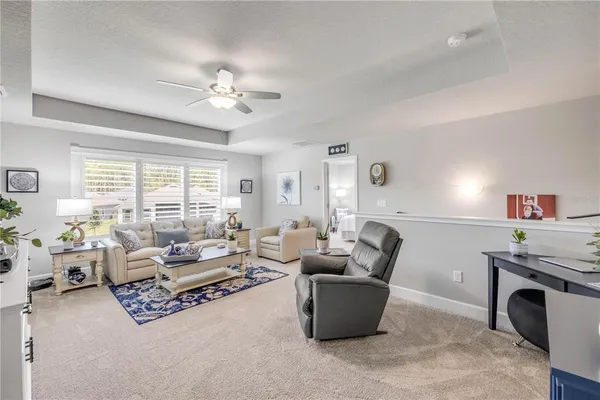 a front view of a house with a big yard and potted plants