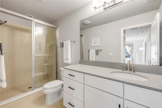 an aerial view of residential houses with outdoor space and a lake view