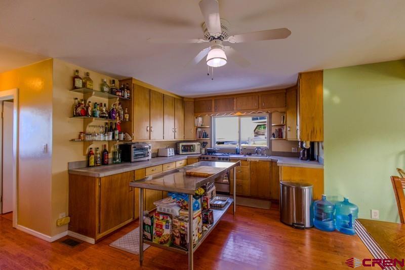 3115 Cr 973 Ignacio, CO 81137 - Photo 16 of 45 a kitchen that has a lot of cabinets and wooden floor