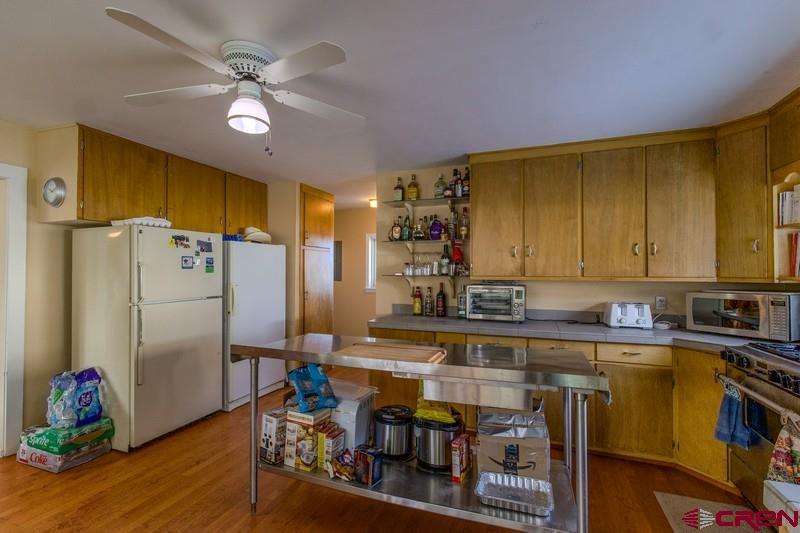 3115 Cr 973 Ignacio, CO 81137 - Photo 17 of 45 a kitchen with stainless steel appliances granite countertop a refrigerator a sink dishwasher and a stove with wooden floor
