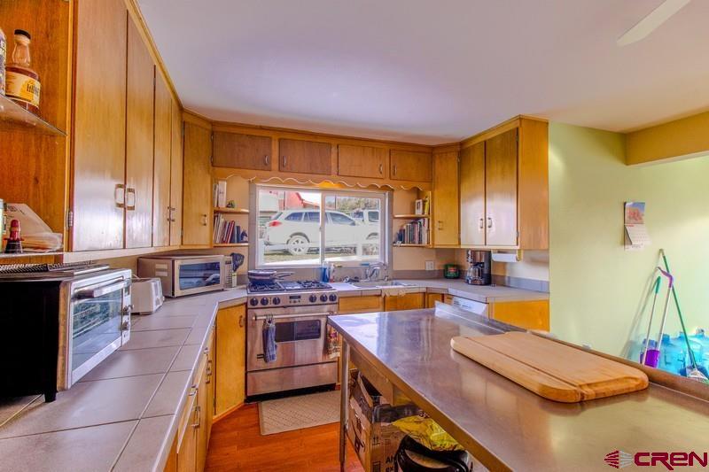 3115 Cr 973 Ignacio, CO 81137 - Photo 19 of 45 a view of a kitchen with kitchen island stainless steel appliances a sink and a counter top space