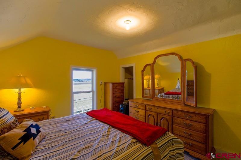 3115 Cr 973 Ignacio, CO 81137 - Photo 28 of 45 a bedroom with a bed and wooden floor