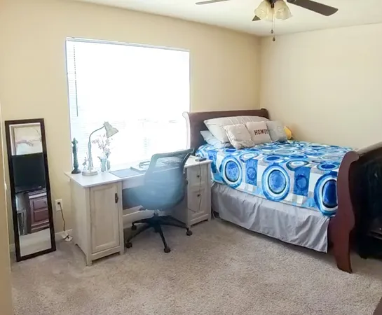 a bedroom with a bed and a table