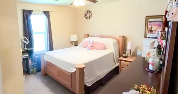 a bedroom with a bed and a chandelier