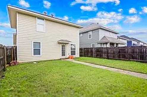 a view of a house with backyard and porch