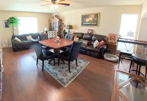 a living room with furniture a table and a large window