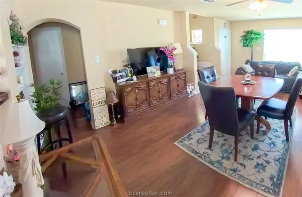 a view of a dining room with furniture and a potted plant