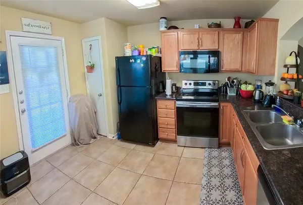 a kitchen with stainless steel appliances granite countertop a refrigerator stove and sink