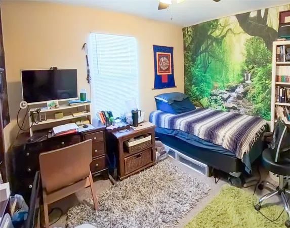 a bedroom with a bed and flat screen tv