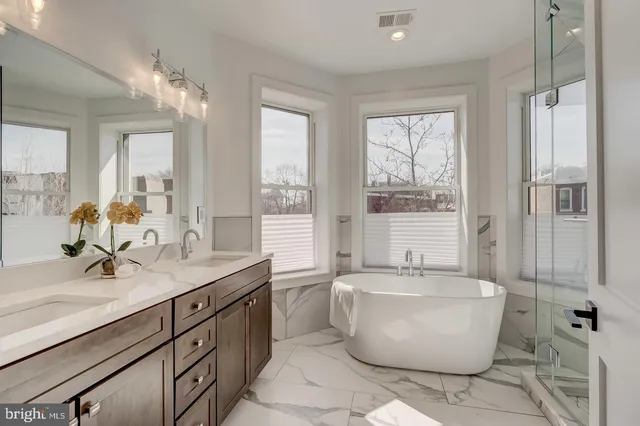 a spacious bathroom with a bathtub and sink
