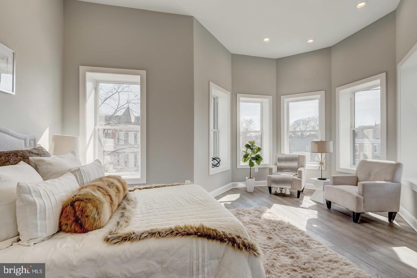 319 R Street Northwest Washington, DC 20001 - Photo 18 of 33 a spacious bedroom with a bed and large windows