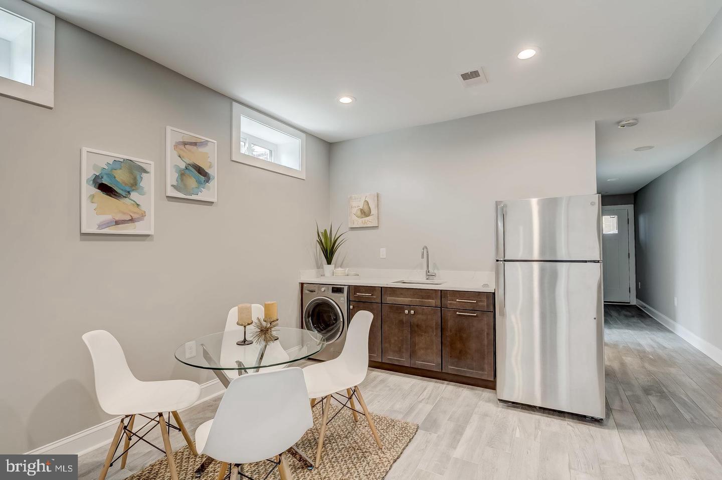 319 R Street Northwest Washington, DC 20001 - Photo 26 of 33 a kitchen with stainless steel appliances granite countertop a dining table chairs and refrigerator