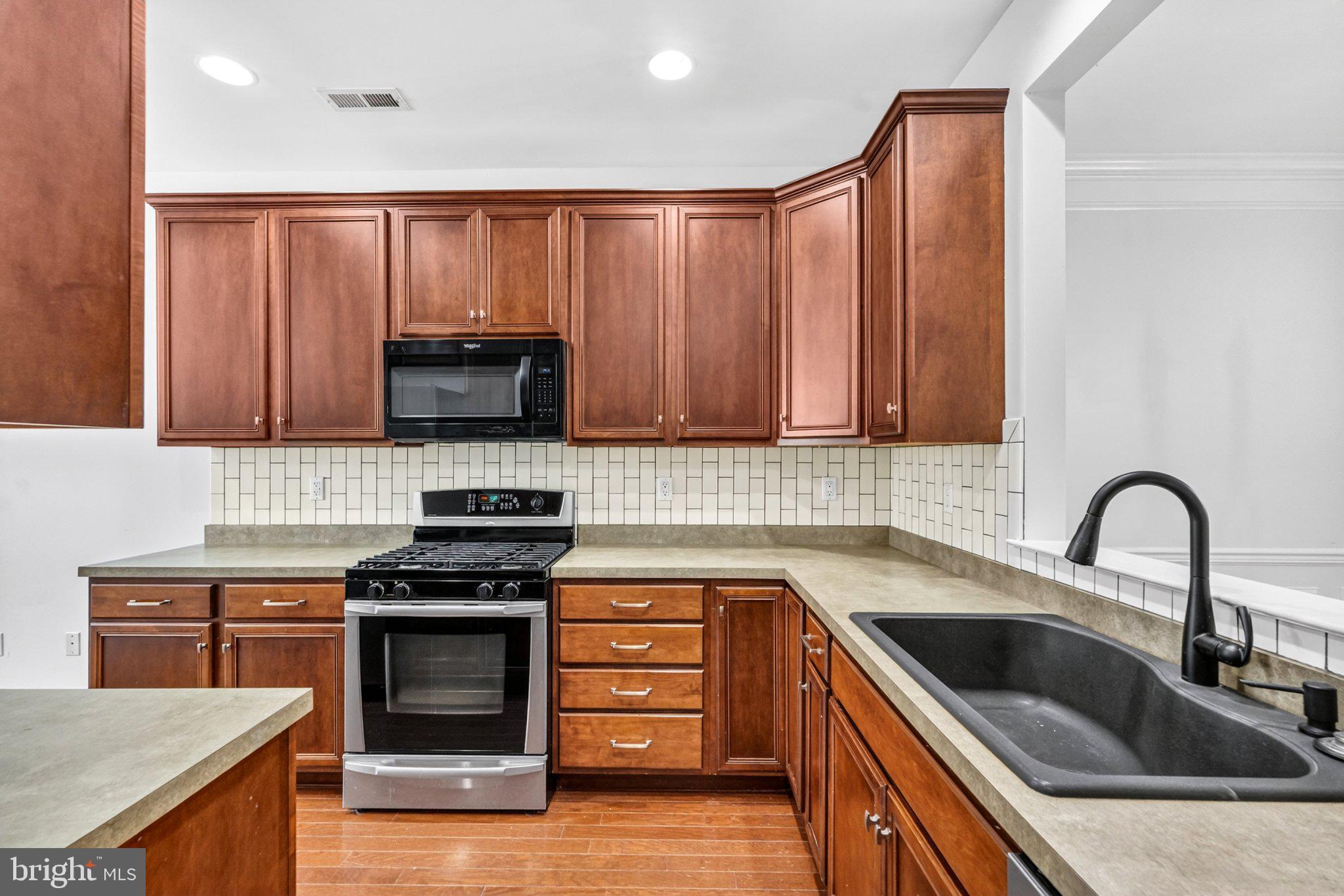 161 Stoyer Road Coatesville, PA 19320 - Photo 12 of 52 Modern kitchen with rich wood tones.