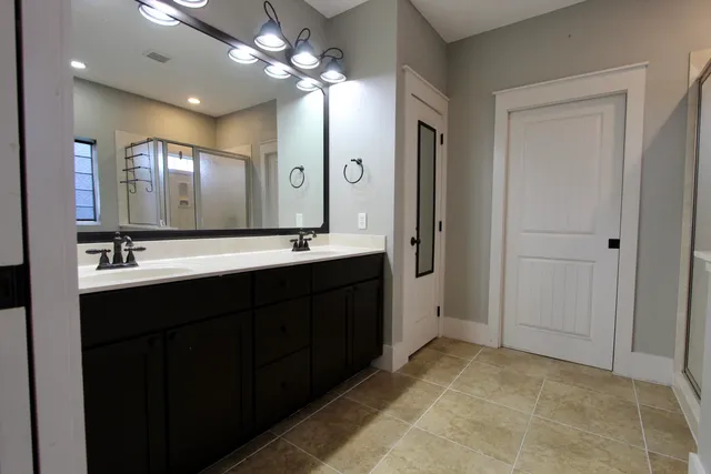 a bathroom with a double vanity sink mirror and double