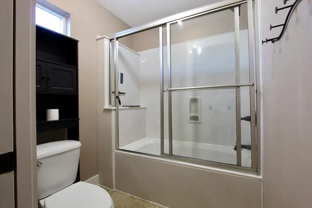 a bathroom with a glass shower door