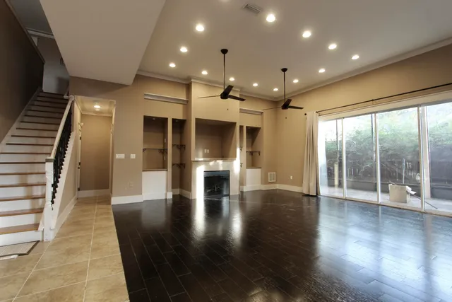 a view of interior space with wooden floor and windows