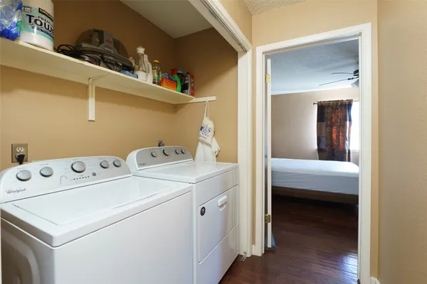 a view of washer and dryer with kitchen in the background