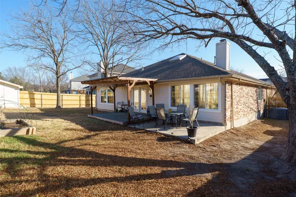a view of a house with backyard porch and sitting area