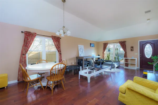 a living room with furniture a window and wooden floor
