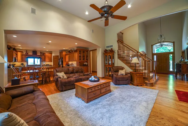 a living room with furniture and a chandelier
