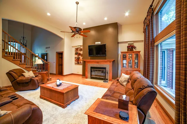 a living room with furniture a fireplace and a flat screen tv