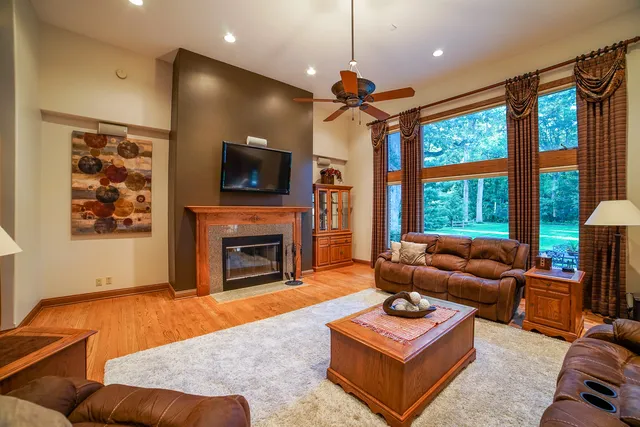 a living room with furniture a flat screen tv and a fireplace