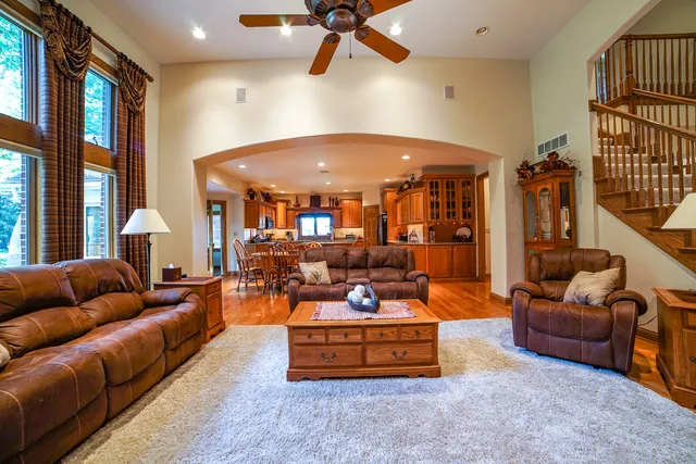 a living room with furniture a ceiling fan and a rug