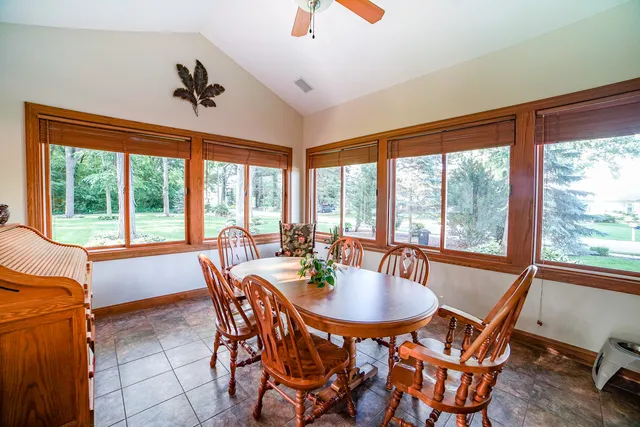 a dining room with furniture window and outside view