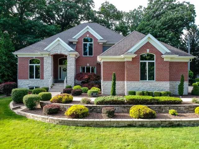 a front view of house with yard and green space