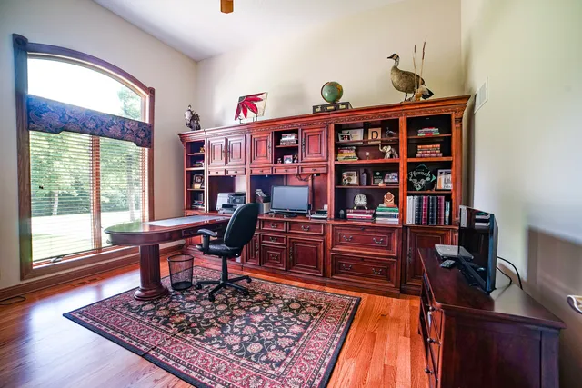a living room with furniture and book shelf