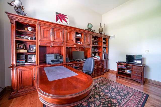 a living room with furniture a rug and a bookshelf