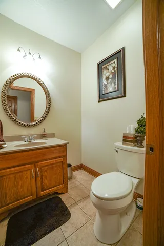 a bathroom with a toilet a sink and mirror