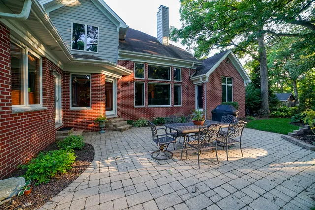 a view of a house with backyard and sitting area