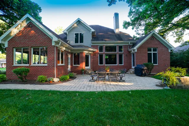 a front view of a house with a yard and potted plants