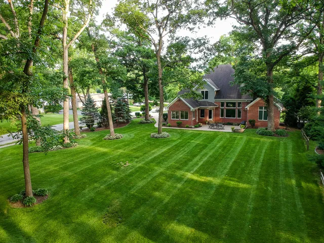 a view of an house with backyard space and garden