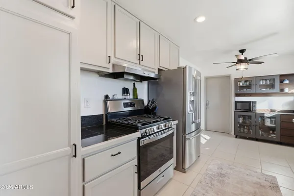 a kitchen with stainless steel appliances granite countertop a stove and a refrigerator