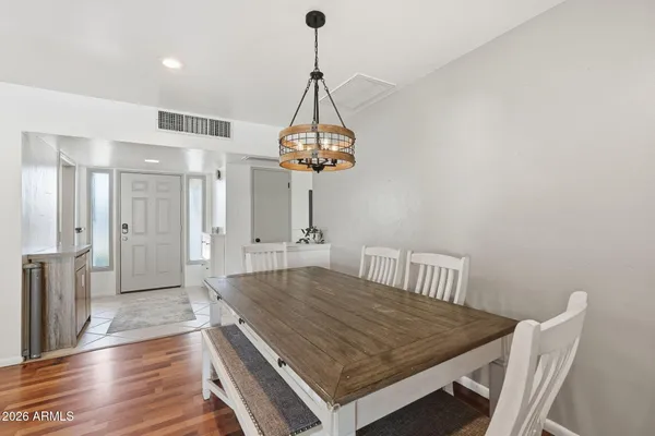 a view of a dining room with a table and chairs