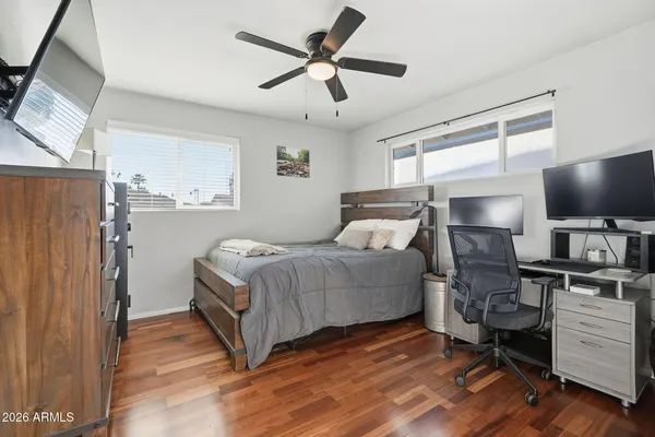 a bedroom with a bed and flat screen tv