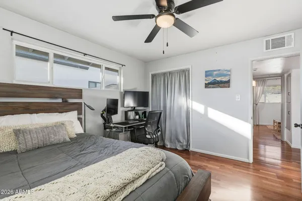 a bedroom with a bed and a flat screen tv