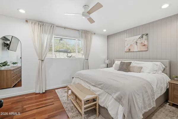 a bedroom with a large bed and a window