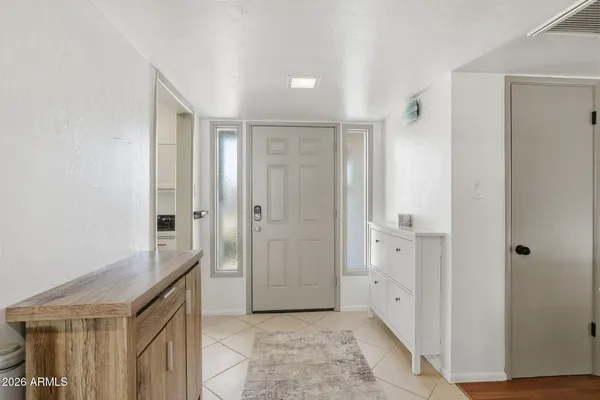 a spacious bathroom with a granite countertop sink and a mirror