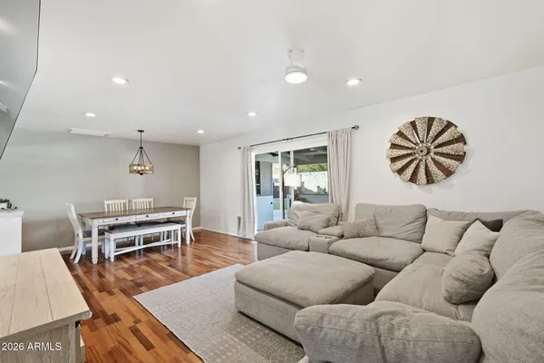 a living room with furniture and a wooden floor