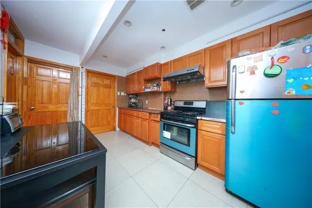 a kitchen with stainless steel appliances a stove a microwave and a refrigerator
