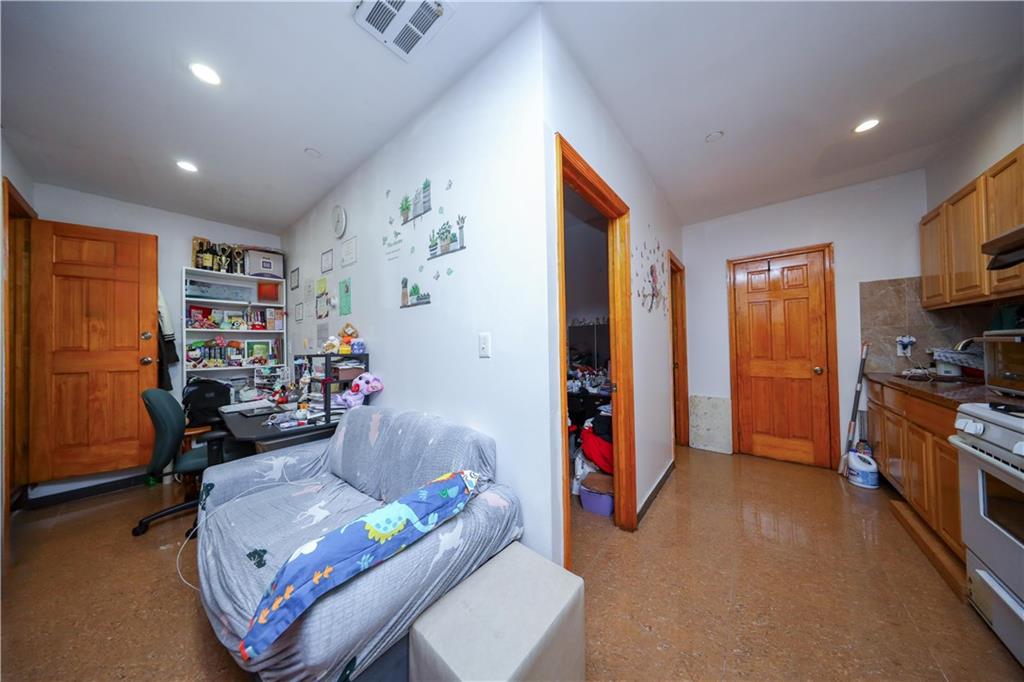 5418 3rd Avenue, Unit 1A Brooklyn, NY 11220 - Photo 5 of 12 a living room with furniture and a flat screen tv