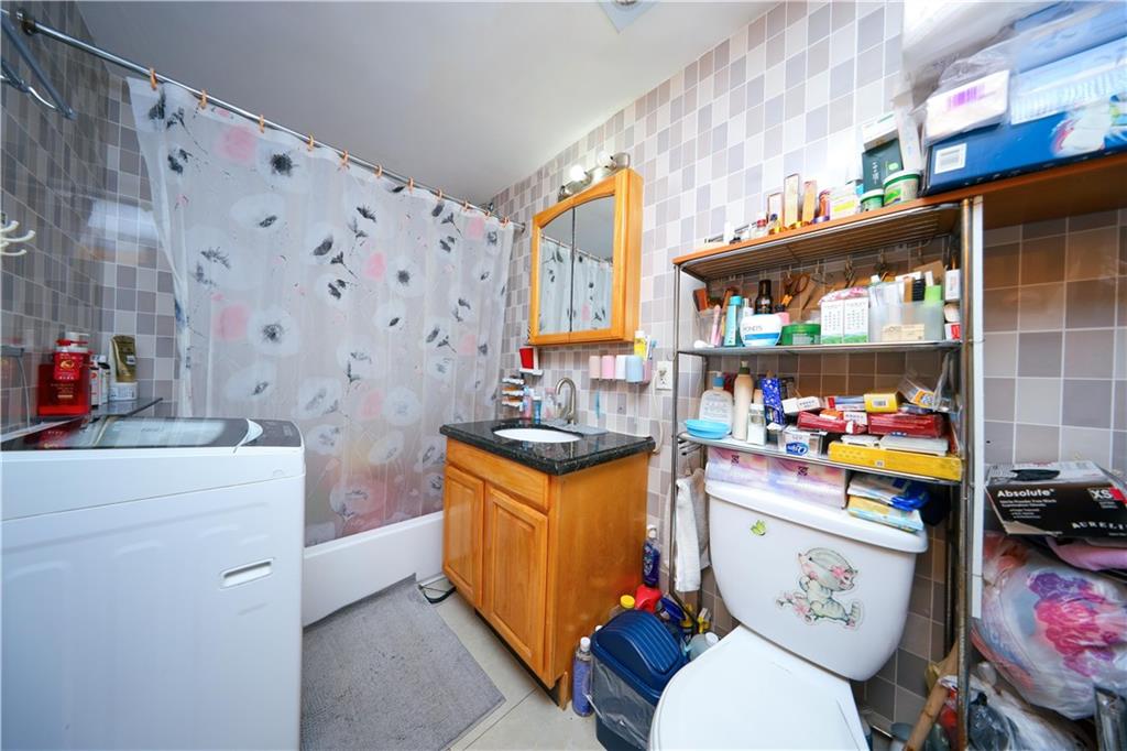 5418 3rd Avenue, Unit 1A Brooklyn, NY 11220 - Photo 10 of 12 a storage room with washer and dryer